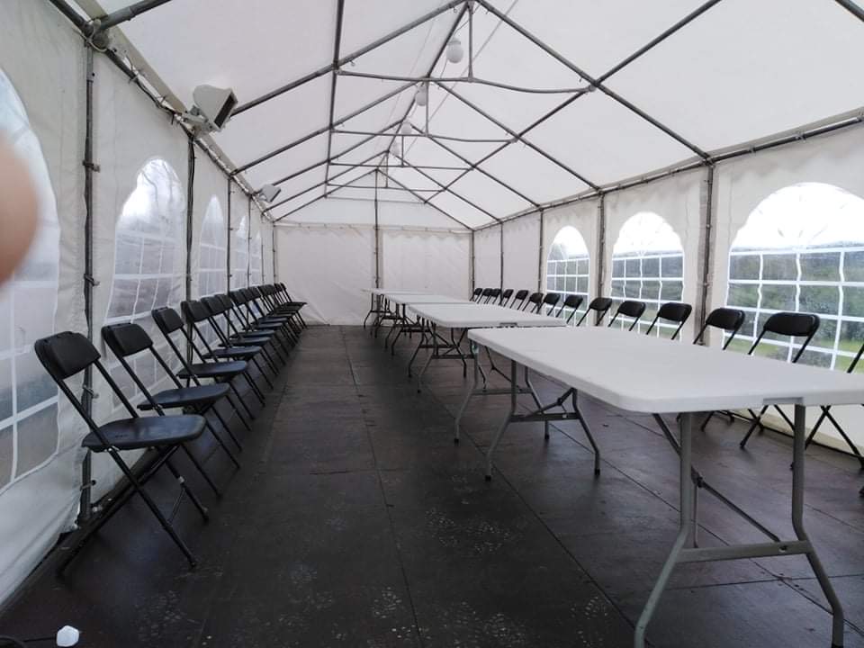 Image of marquee for hire with seats, tables, lights and heat